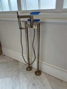 Freestanding tub with a modern floor-mounted filler from delta brizo in a luxury master bath