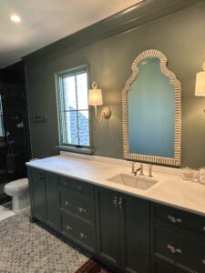 Charlotte plumber repairing bathroom faucet and updating tile plumbing fixtures