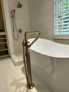Charlotte plumber remodeling bathroom with freestanding bathtub and shower installation