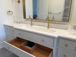 Luxury dual master bathroom vanity in Charlotte NC expert plumber installation with beautiful faucet fixtures in brass color