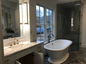 Luxury master bath with custom tub filler, elegant lighting, and precision plumbing craftsmanship in a premium Charlotte home