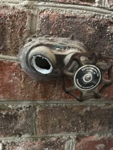 licensed plumber repairing leaking hose bib sillcock in Charlotte home