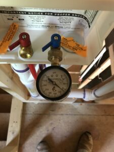 plumbing leak detection using pressure test gauge by licensed plumber