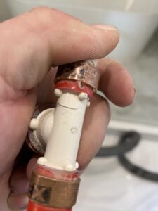 licensed plumber detecting and repairing PEX pipe leak in Waxhaw home