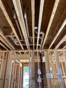 Professional plumber repairing ceiling plumbing and drains in a luxury home by trusted local expert