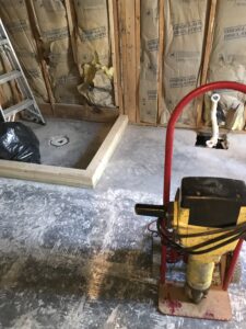 bathroom plumbing rough-in and remodel work during concrete floor installation