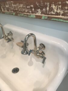 dual cast iron wall mount service sink installed in custom home utility space