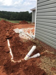 Licensed Charlotte plumber locating and servicing a sewer line — professional sewer solutions