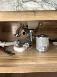 Charlotte plumber fixing a sink drain — trusted professional plumbing service