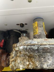 icensed plumber repairing tankless water heater leak and error code issues
